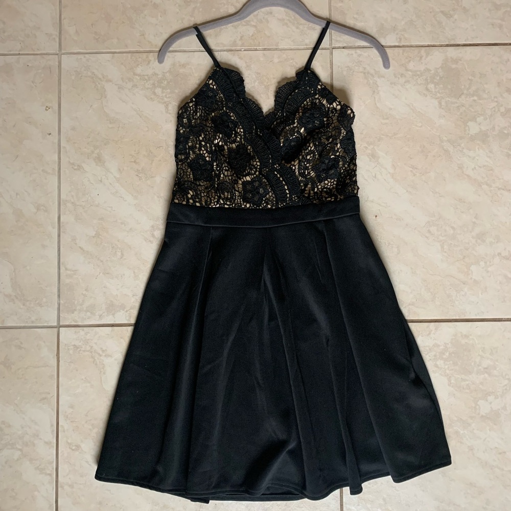 Beautiful little black dress with appliqué over nude fabric. Francesca’s size M